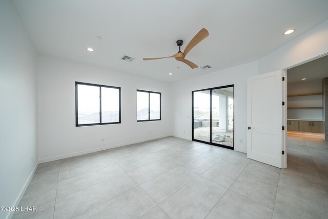 spare room featuring recessed lighting, visible vents, and a ceiling fan