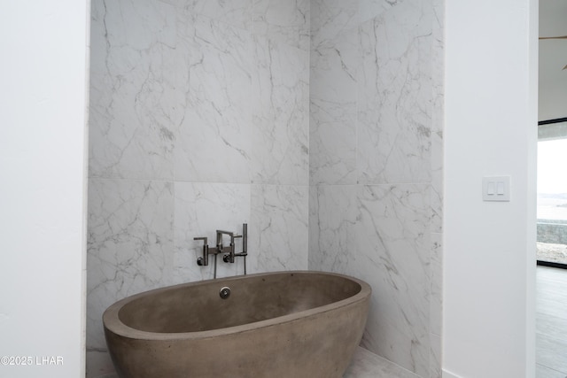 full bath featuring a soaking tub