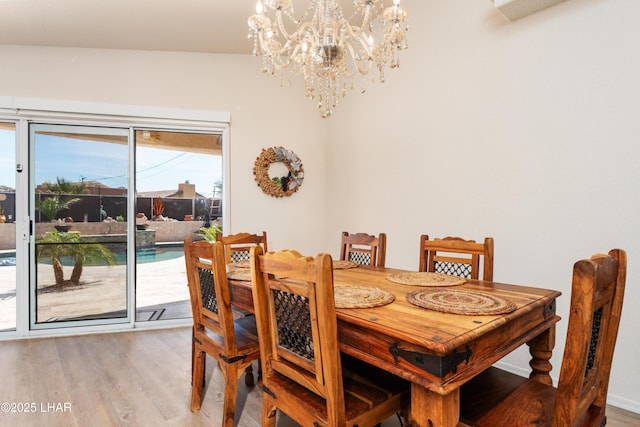 dining space featuring a notable chandelier and wood finished floors