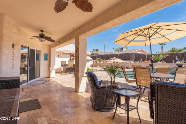 view of patio with a fenced in pool, outdoor dining area, and a fenced backyard