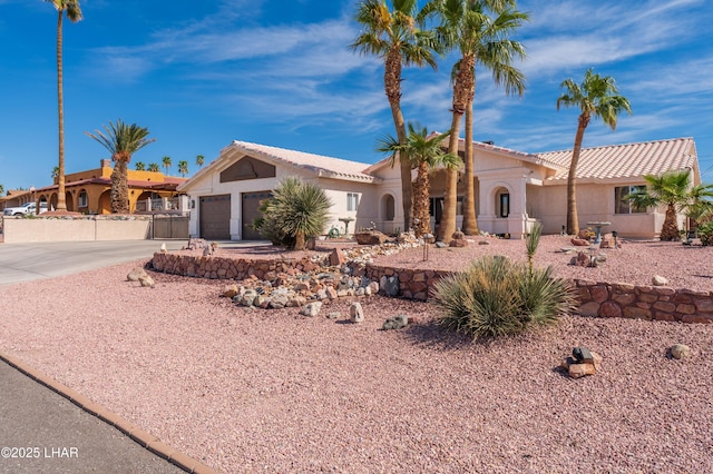 view of front of house featuring driveway, an attached garage, and stucco siding