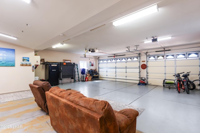 garage with refrigerator and a garage door opener