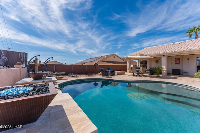 view of pool with a fenced in pool, outdoor dining area, a patio area, a fenced backyard, and a fire pit