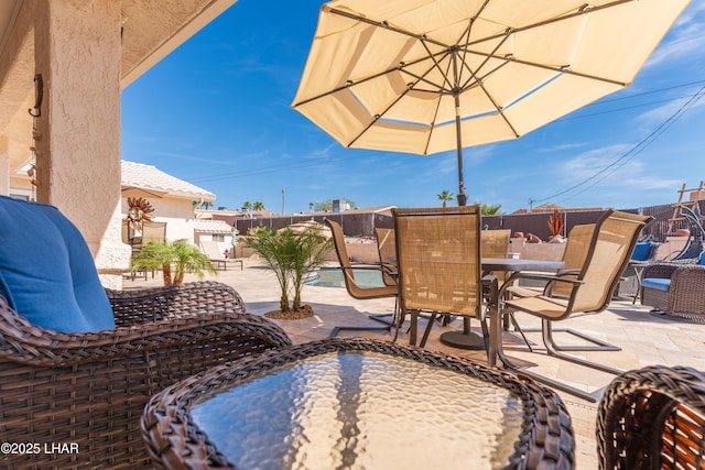 view of patio / terrace with outdoor dining space and fence