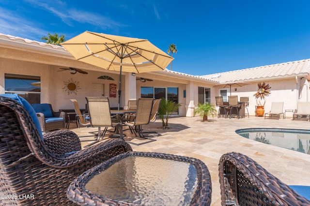 view of patio with a ceiling fan and outdoor dining space