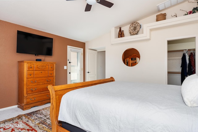 bedroom featuring vaulted ceiling, ceiling fan, a closet, and carpet flooring