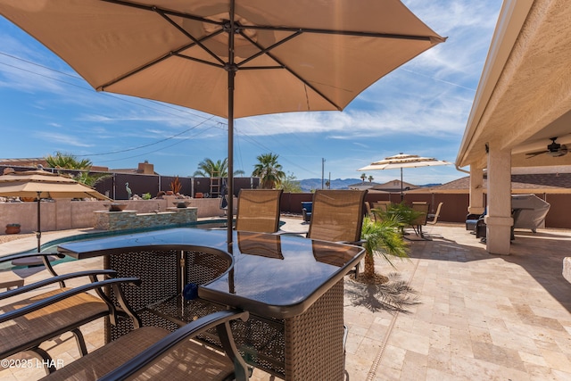 view of patio featuring a fenced backyard, a ceiling fan, outdoor dining area, and a fenced in pool