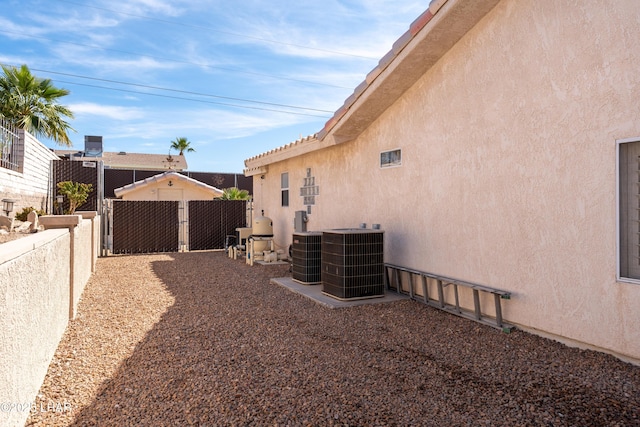 exterior space with fence and central AC