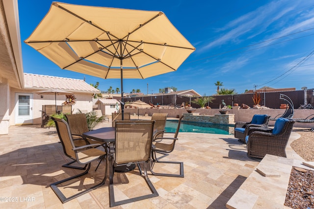 view of patio / terrace featuring a fenced backyard, outdoor dining area, and a fenced in pool