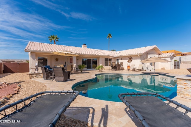 view of pool with outdoor dining space, a patio area, fence, and a fenced in pool