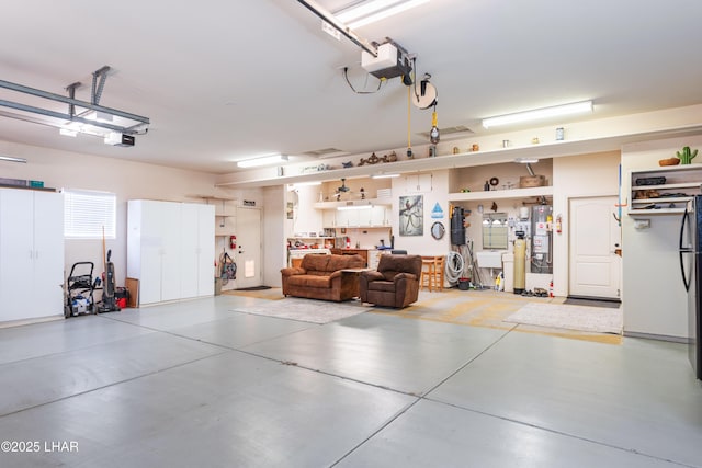 garage with gas water heater and a garage door opener