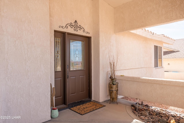 property entrance with stucco siding