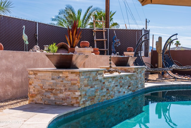 view of swimming pool with a fenced in pool and fence