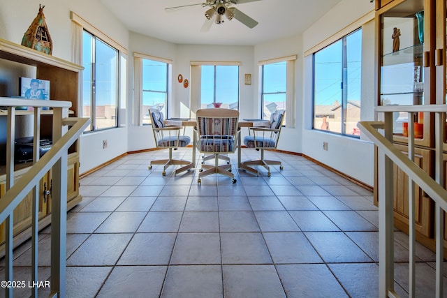 interior space with ceiling fan and a water view