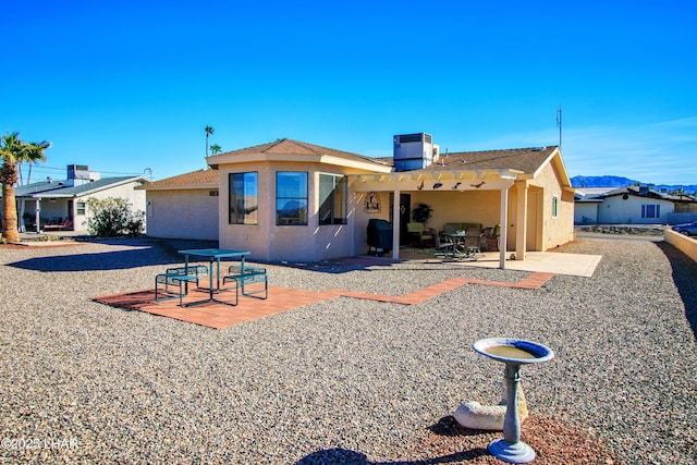 rear view of house featuring a patio and cooling unit