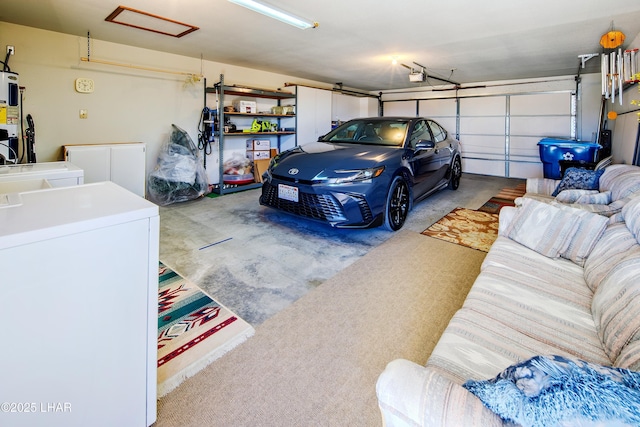 garage featuring water heater, a garage door opener, and independent washer and dryer