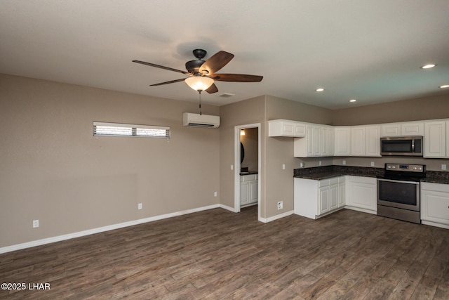 679 Apache Dr, Lake Havasu City, AZ 86406 - kitchen featuring stainless steel appliances, a wall mounted air conditioner, dark countertops, dark wood-style flooring, and recessed lighting