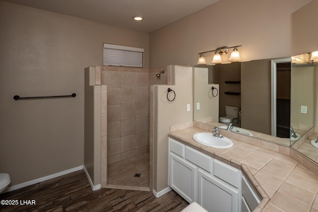 679 Apache Dr, Lake Havasu City, AZ 86406 - bathroom featuring wood finished floors, a walk in shower, vanity, and recessed lighting