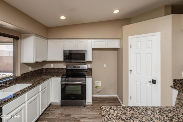 679 Apache Dr, Lake Havasu City, AZ 86406 - kitchen with stainless steel appliances, white cabinetry, dark stone counters, and recessed lighting