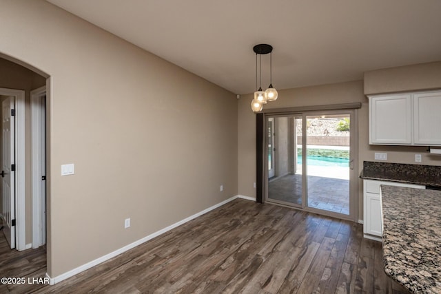 679 Apache Dr, Lake Havasu City, AZ 86406 - unfurnished dining area with dark wood-type flooring and arched walkways