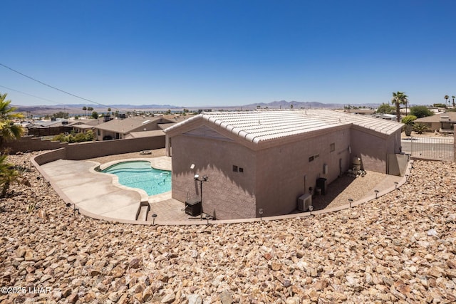 679 Apache Dr, Lake Havasu City, AZ 86406 - view of property exterior featuring stucco siding, a fenced backyard, a tiled roof, and a mountain view