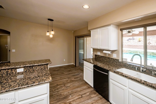 679 Apache Dr, Lake Havasu City, AZ 86406 - kitchen with black dishwasher, wood finished floors, white cabinetry, dark stone countertops, and recessed lighting