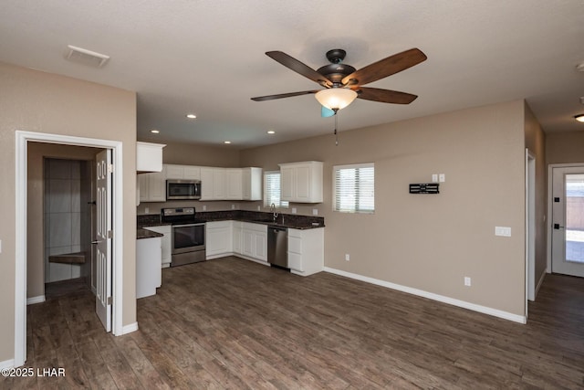 679 Apache Dr, Lake Havasu City, AZ 86406 - kitchen featuring appliances with stainless steel finishes, dark countertops, ceiling fan, dark wood-style flooring, and recessed lighting
