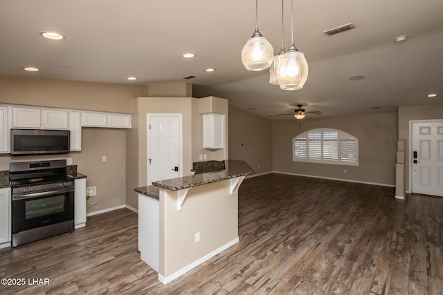 679 Apache Dr, Lake Havasu City, AZ 86406 - kitchen with appliances with stainless steel finishes, white cabinetry, dark stone countertops, ceiling fan, and recessed lighting