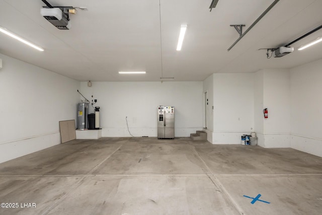 679 Apache Dr, Lake Havasu City, AZ 86406 - garage featuring a garage door opener, electric water heater, and stainless steel refrigerator with ice dispenser