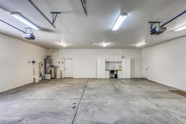 garage featuring a garage door opener and water heater