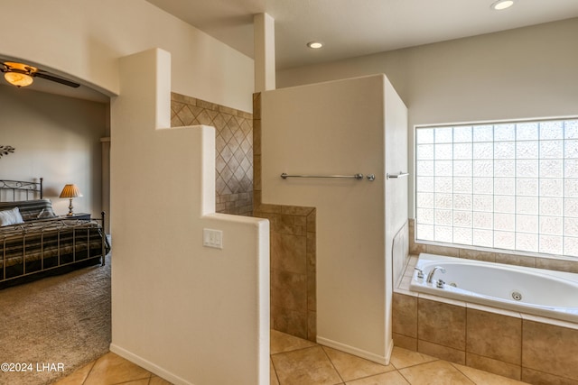 bathroom featuring a relaxing tiled tub, tile patterned floors, and ceiling fan