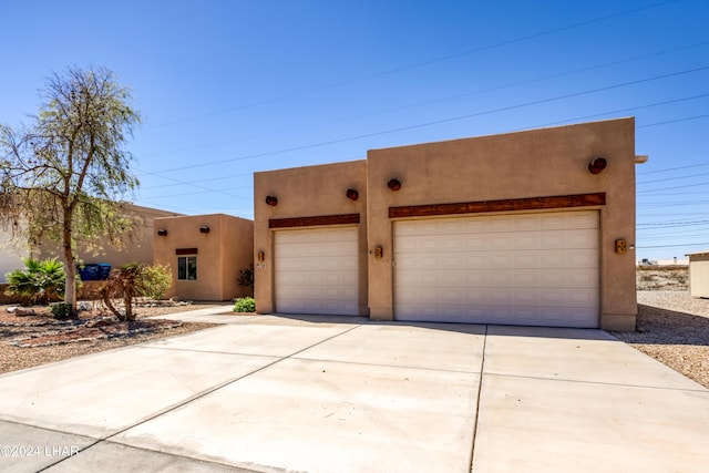 pueblo-style home featuring a garage