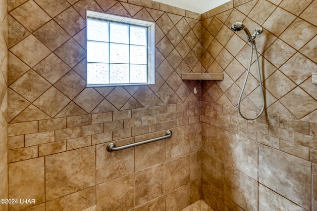 bathroom with a tile shower