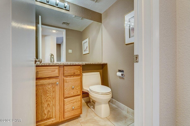 1650 Smoketree Ave Unit 202, Lake Havasu City, AZ 86403 - bathroom featuring tile patterned flooring, vanity, a textured ceiling, and toilet