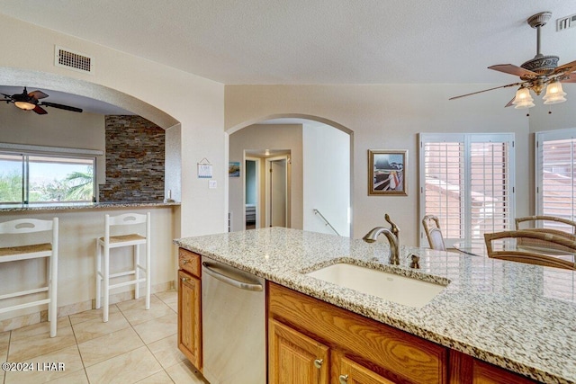 1650 Smoketree Ave Unit 202, Lake Havasu City, AZ 86403 - kitchen with dishwasher, light stone countertops, sink, and a textured ceiling