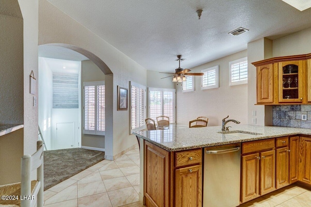 1650 Smoketree Ave Unit 202, Lake Havasu City, AZ 86403 - kitchen featuring sink, light stone countertops, kitchen peninsula, and dishwasher