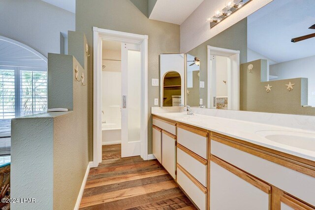 1650 Smoketree Ave Unit 202, Lake Havasu City, AZ 86403 - bathroom featuring hardwood / wood-style flooring, vanity, shower / bathtub combination, and ceiling fan