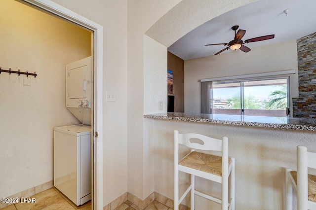 1650 Smoketree Ave Unit 202, Lake Havasu City, AZ 86403 - kitchen featuring stacked washer / drying machine, ceiling fan, and light tile patterned flooring