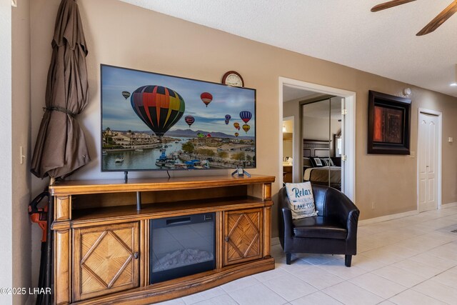 777 Harrah Way Unit 112, Lake Havasu City, AZ 86403 - living area featuring light tile patterned floors, baseboards, a ceiling fan, and a textured ceiling