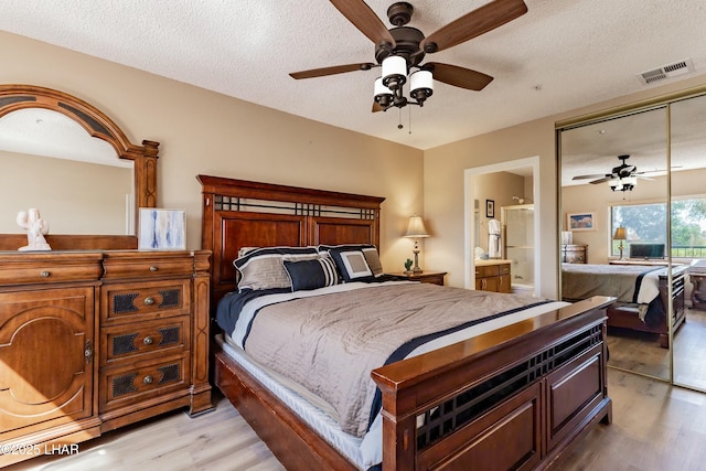 777 Harrah Way Unit 112, Lake Havasu City, AZ 86403 - bedroom with a closet, light wood-type flooring, a textured ceiling, a ceiling fan, and visible vents