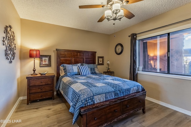 777 Harrah Way Unit 112, Lake Havasu City, AZ 86403 - bedroom featuring a ceiling fan, baseboards, light wood-type flooring, and a textured ceiling
