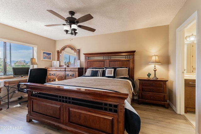 777 Harrah Way Unit 112, Lake Havasu City, AZ 86403 - bedroom featuring light wood-style floors, a textured ceiling, connected bathroom, and ceiling fan