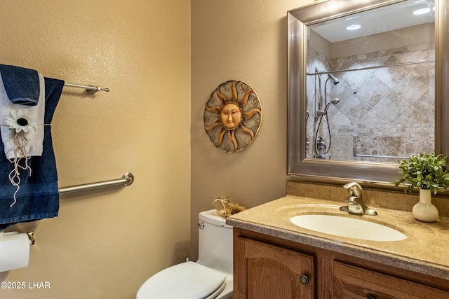 777 Harrah Way Unit 112, Lake Havasu City, AZ 86403 - bathroom featuring a tile shower, toilet, vanity, and a textured wall