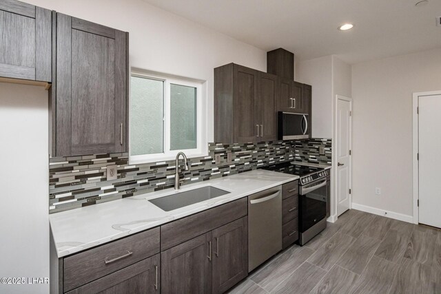 2080 Swanson Ave Unit F, Lake Havasu City, AZ 86403 - kitchen with dark brown cabinets, light countertops, a sink, stainless steel appliances, and backsplash