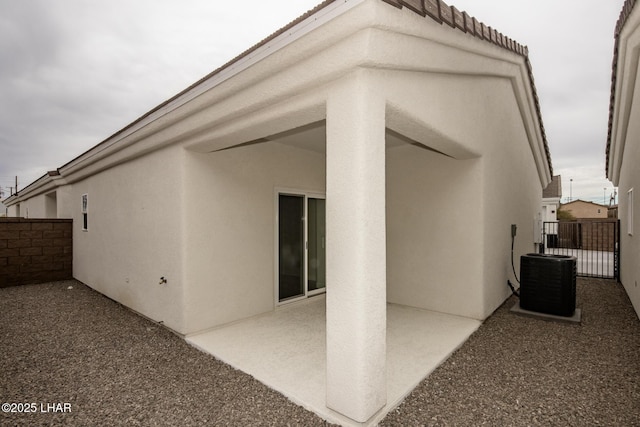 2080 Swanson Ave Unit F, Lake Havasu City, AZ 86403 - rear view of house with a patio, stucco siding, central AC unit, a tile roof, and fence