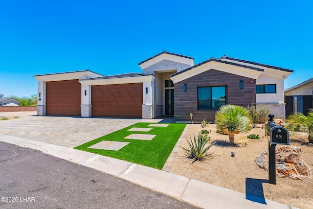 816 Isola Bella Loop, Lake Havasu City, AZ 86403 - view of front of home featuring a garage, decorative driveway, and brick siding