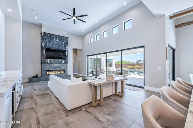 816 Isola Bella Loop, Lake Havasu City, AZ 86403 - living area with recessed lighting, a high end fireplace, a towering ceiling, and a ceiling fan