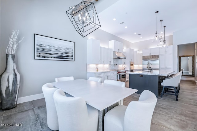 816 Isola Bella Loop, Lake Havasu City, AZ 86403 - dining area featuring a chandelier and a towering ceiling