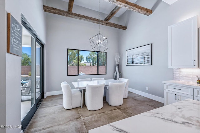 816 Isola Bella Loop, Lake Havasu City, AZ 86403 - dining room with beam ceiling, healthy amount of natural light, a chandelier, concrete floors, and a towering ceiling