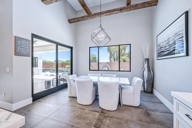 816 Isola Bella Loop, Lake Havasu City, AZ 86403 - dining area with finished concrete flooring, healthy amount of natural light, beamed ceiling, a high ceiling, and a chandelier